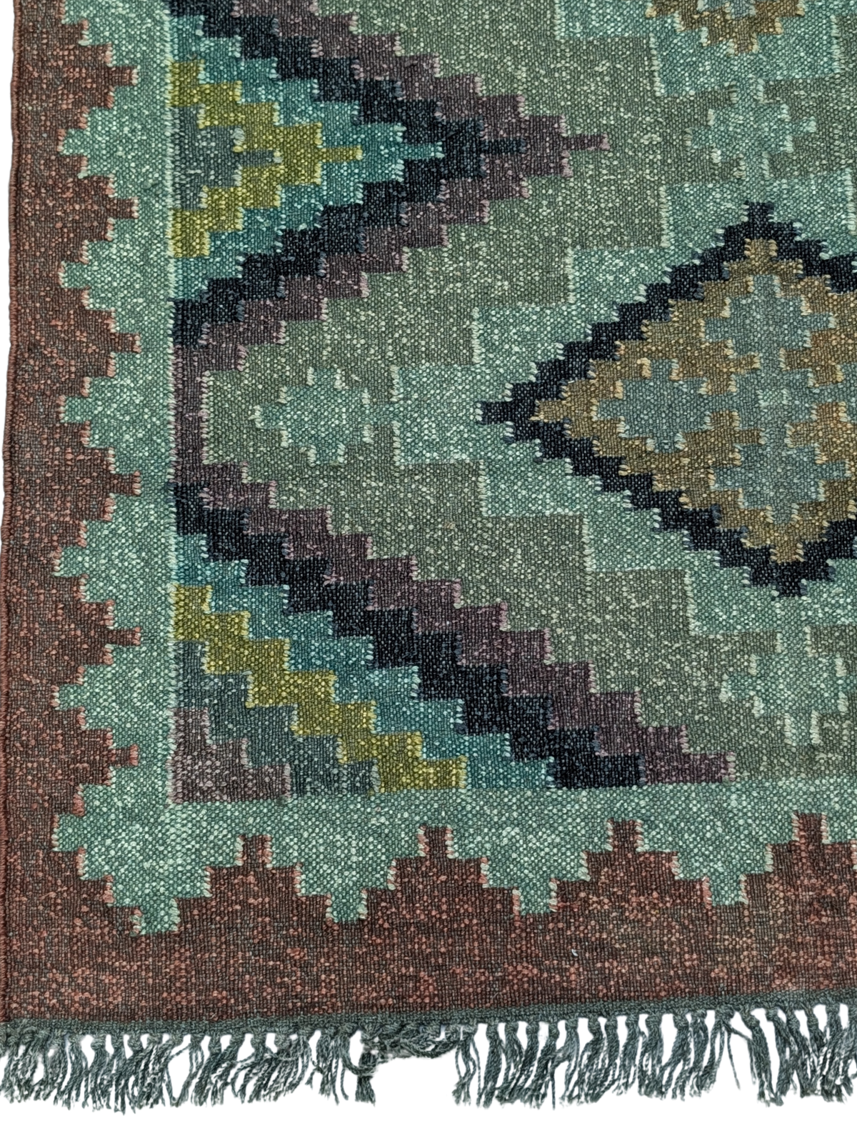Inspired by the serene transition from day to night, the Dusk Haven Kilim Rug blends rich, moody hues with timeless geometric patterns. Handwoven by skilled artisans using premium wool, this flatweave rug features a mesmerizing diamond motif set against a soothing palette of deep teal, forest green, muted indigo, and earthy brown. The intricate stepped border adds a sense of structure while maintaining a soft, organic aesthetic.