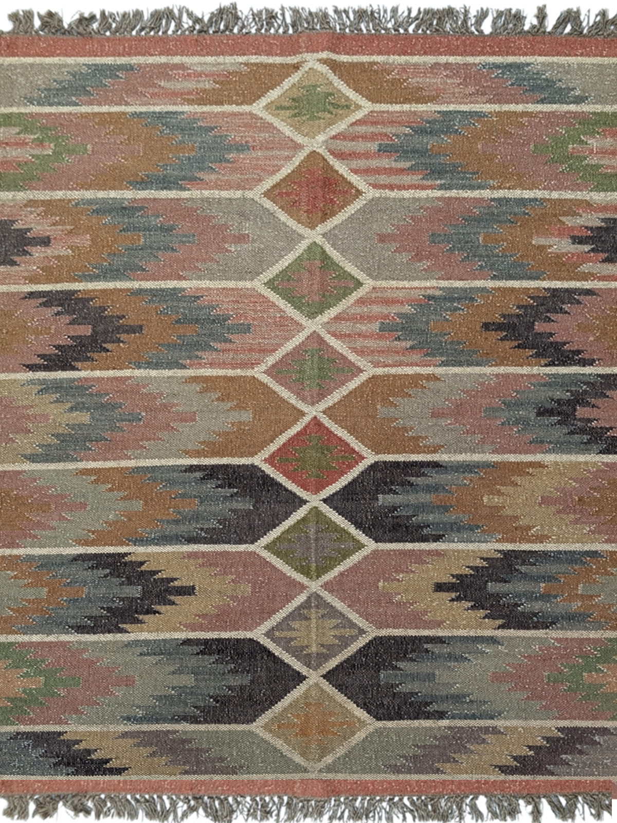 Inspired by the raw beauty of rugged landscapes, the Echoes of the Highlands Kilim Rug brings a sense of tranquility and timeless craftsmanship to your home. Handwoven by skilled artisans, this wool flatweave rug features a mesmerizing geometric design with earthy hues of sage green, terracotta, charcoal, soft beige, and muted blues, evoking the essence of misty highlands and rolling hills. Its intricate diamond motifs and horizontal patterns create a harmonious blend of tradition and modernity, making it a