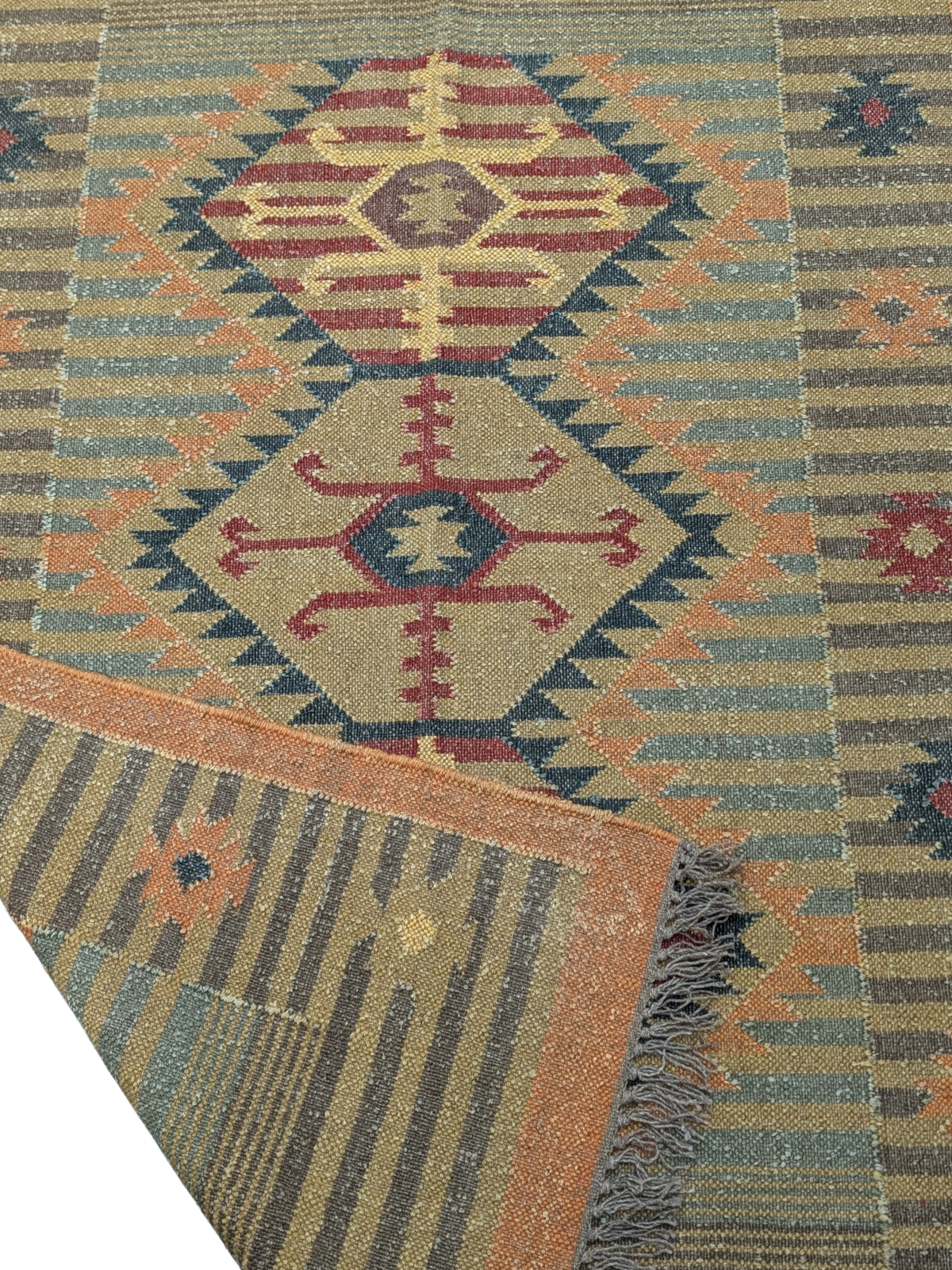Inspired by the sunlit landscapes of the Southwest, the Golden Mesa Kilim Rug radiates warmth and character. Handwoven by skilled artisans using traditional techniques, this wool flatweave rug features a striking central medallion with intricate tribal motifs, framed by a structured border in golden ochre, deep red, and muted blue-gray tones. Subtle striped patterns and delicate geometric details enhance its timeless appeal.