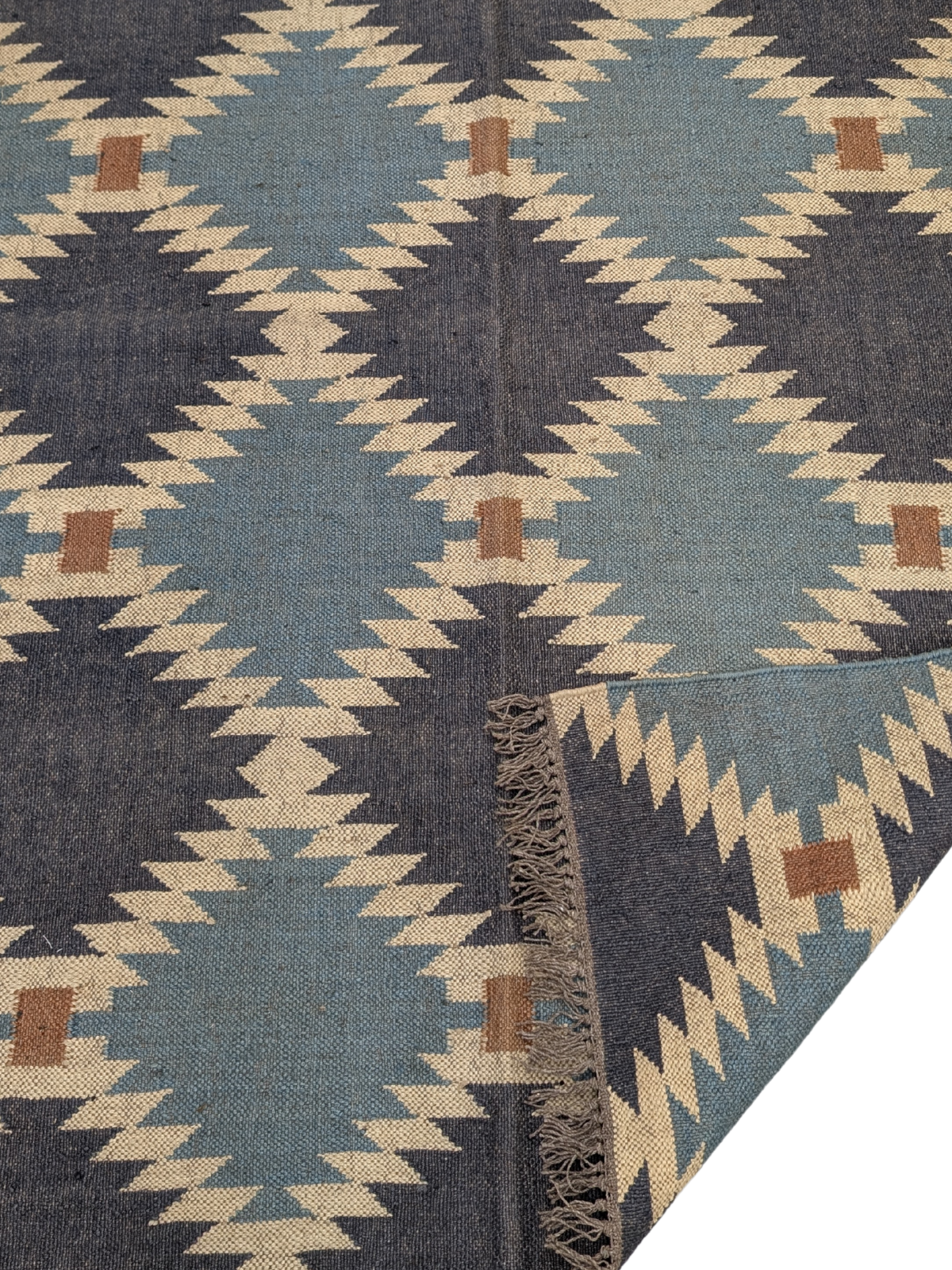 The Rustic Vistas Kilim Rug is a stunning handwoven masterpiece that blends timeless geometric design with a calming, earthy color palette. Featuring deep navy, soft sky blue, warm beige, and rustic brown, this flatweave wool rug is inspired by the natural landscapes of rolling hills and open skies. Its symmetrical tribal motifs create a bold yet balanced aesthetic, perfect for adding warmth and texture to your home.