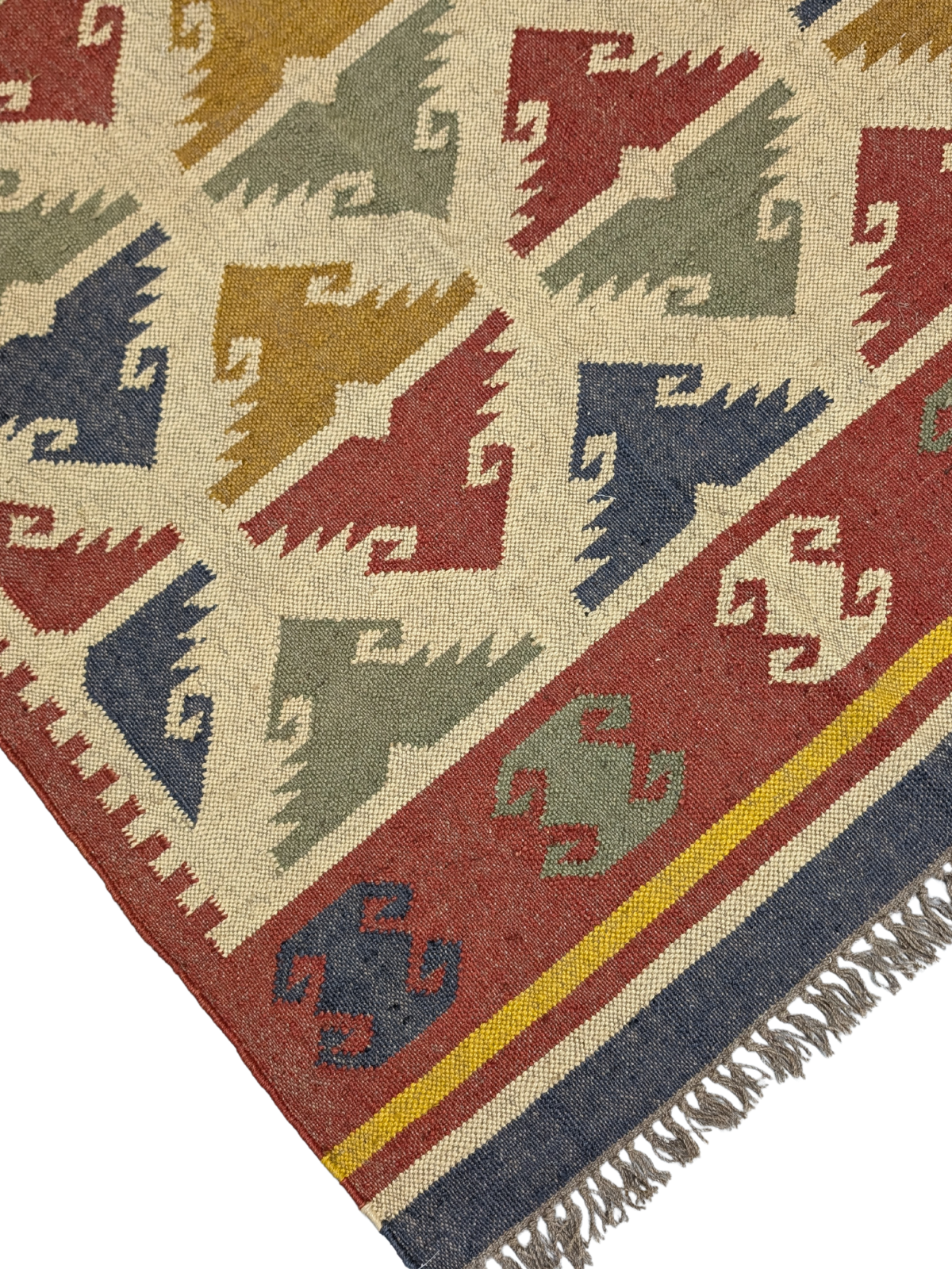 The Timeless Tribe Kilim Rug is a striking blend of tradition and artistry, showcasing bold geometric patterns inspired by ancient tribal motifs. Handwoven from high-quality wool, this flatweave rug features a rich, earthy palette of deep reds, mustard yellows, forest greens, navy blues, and warm ivory, making it a versatile statement piece for any home. Its intricate detailing and vibrant colors add warmth and character, perfect for those who appreciate heritage craftsmanship with a modern edge.