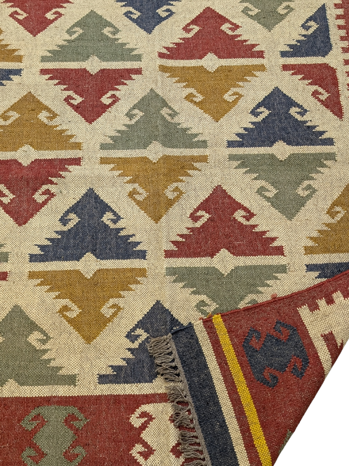 The Timeless Tribe Kilim Rug is a striking blend of tradition and artistry, showcasing bold geometric patterns inspired by ancient tribal motifs. Handwoven from high-quality wool, this flatweave rug features a rich, earthy palette of deep reds, mustard yellows, forest greens, navy blues, and warm ivory, making it a versatile statement piece for any home. Its intricate detailing and vibrant colors add warmth and character, perfect for those who appreciate heritage craftsmanship with a modern edge.