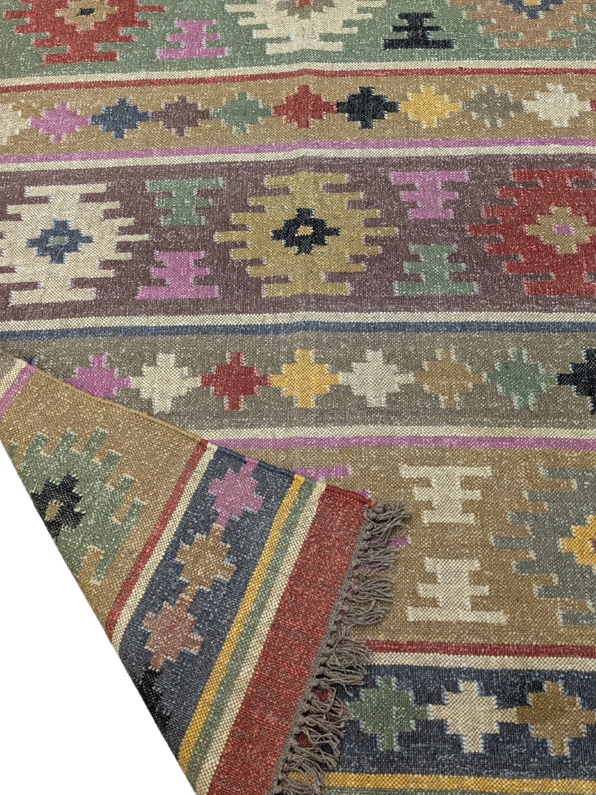 The Wanderer’s Mosaic Kilim Rug is a vibrant celebration of nomadic artistry, designed to infuse your space with eclectic charm and cultural richness. Handwoven by skilled artisans using premium wool, this rug showcases a mesmerizing patchwork of geometric and tribal motifs, arranged in striking horizontal bands. The warm, earthy palette—featuring deep reds, forest greens, golden yellows, rich purples, and soft neutrals—evokes the spirit of adventure and storytelling found in traditional kilim designs.