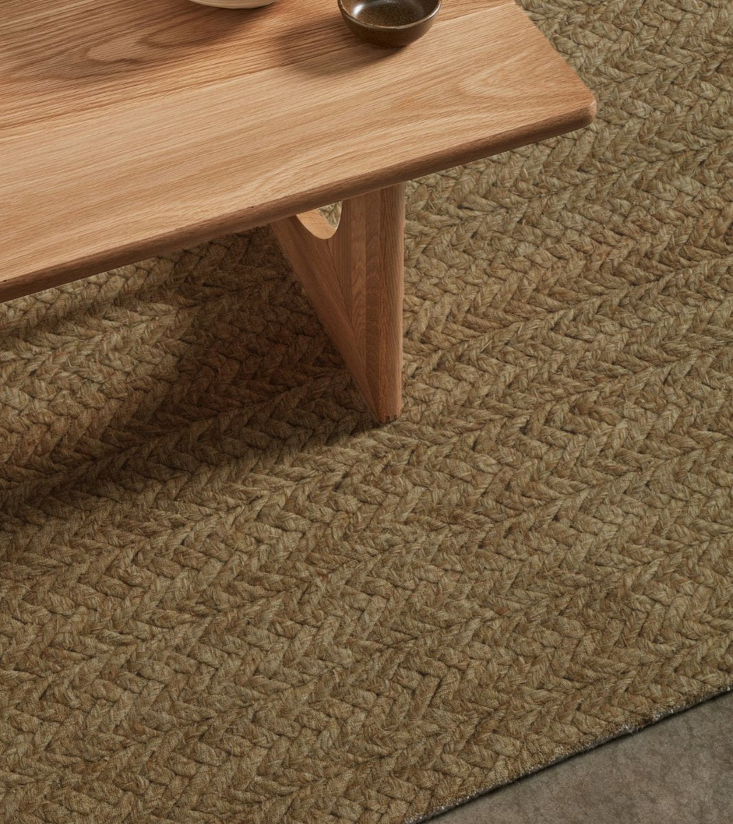 Abaca abaca sample swatch held against timber and linen
