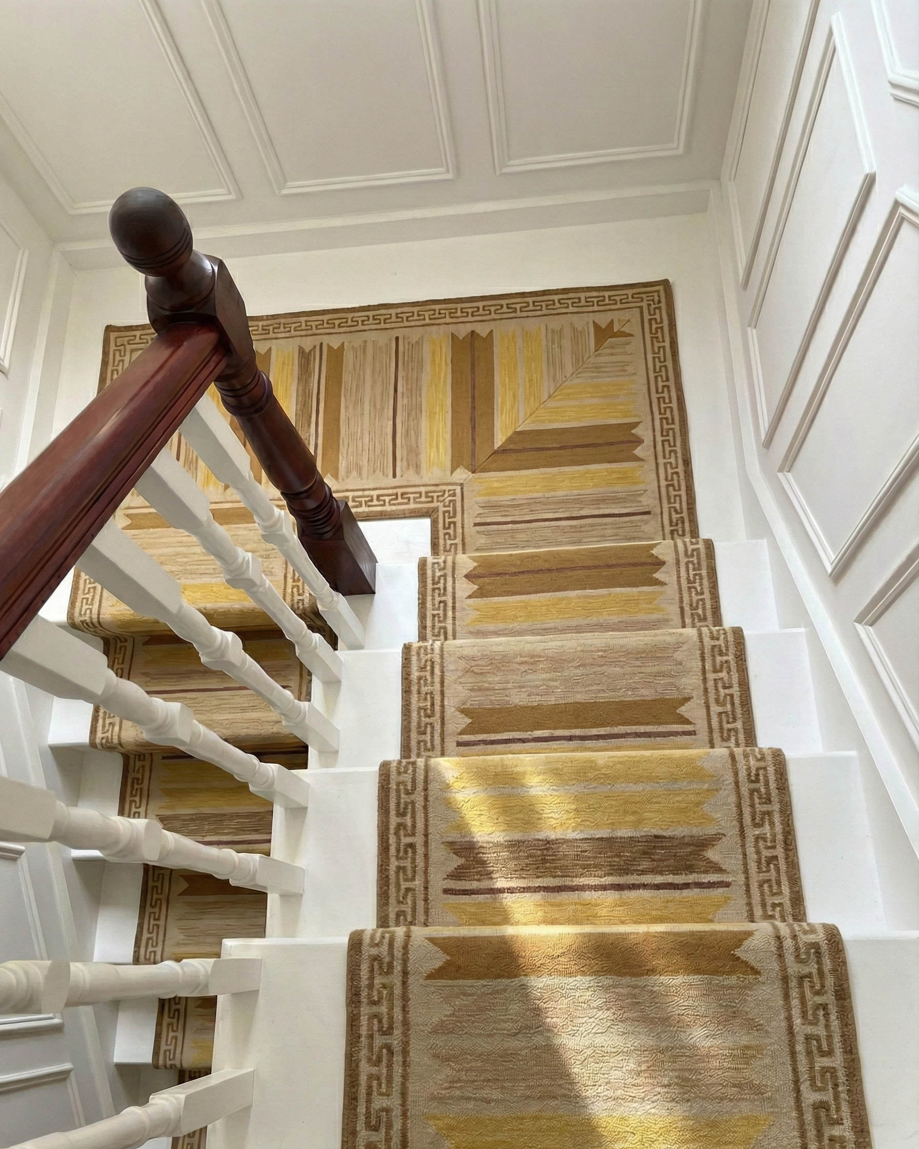 Aegean Block Border Runner-Mustard wool stair runner styled on a staircase in a designed interior