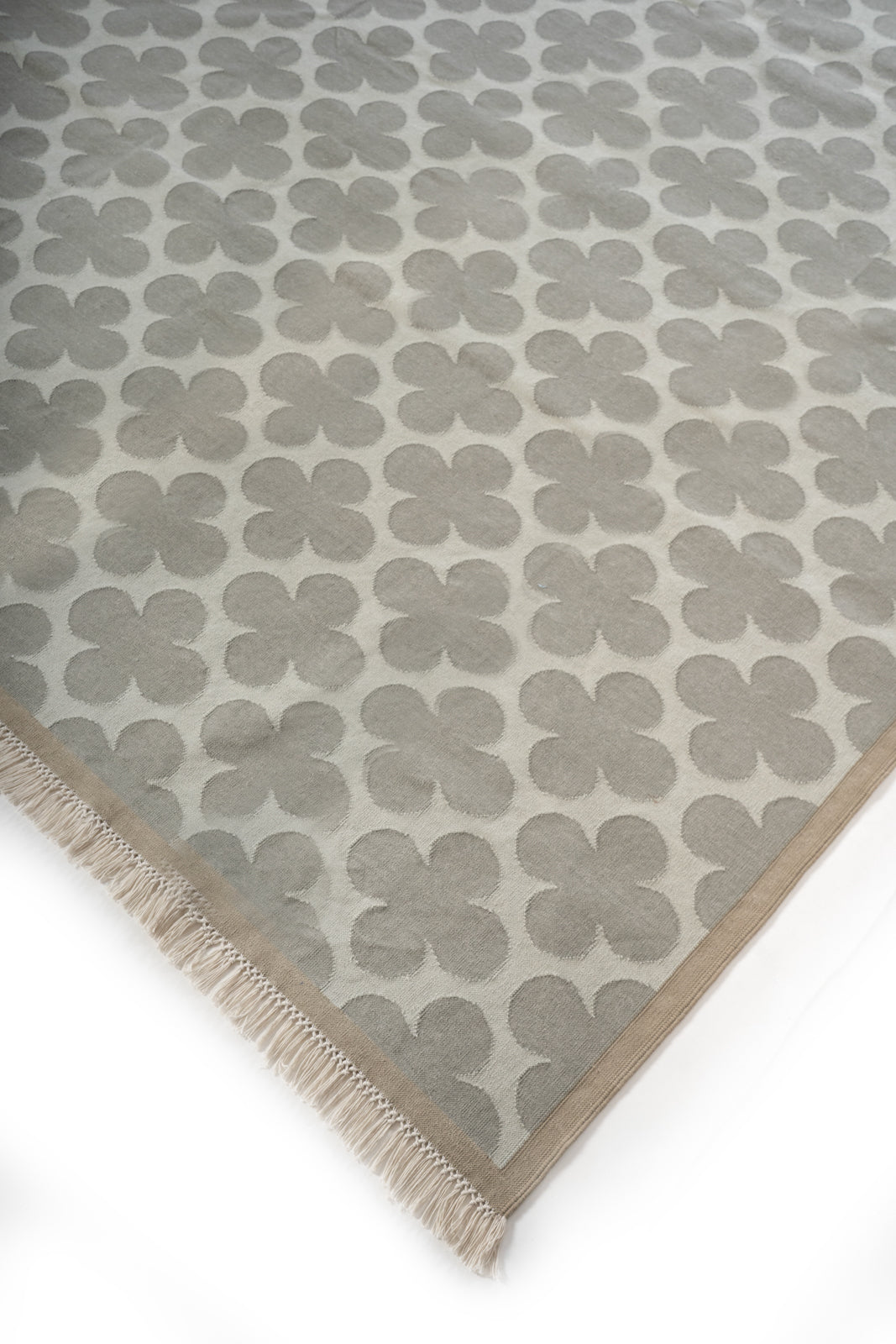 Ash Bloom Flatweave Rug close-up showing the cotton pile and floral motif