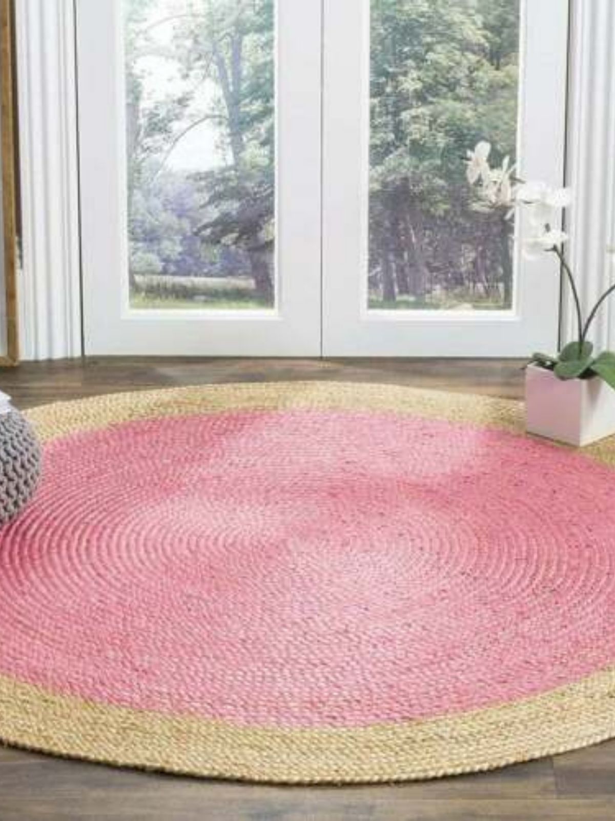 Asmara bordered round rug-Pink cotton rug styled in a living room interior