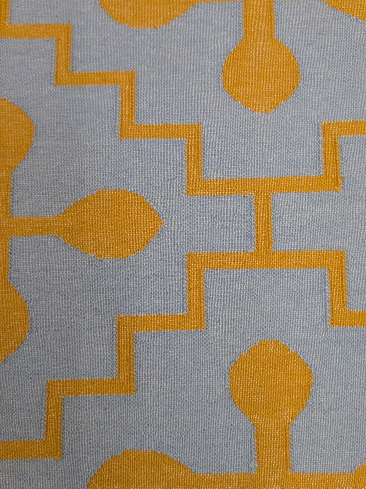 Azure Bloom Flatweave Rug cotton rug styled in a living room interior