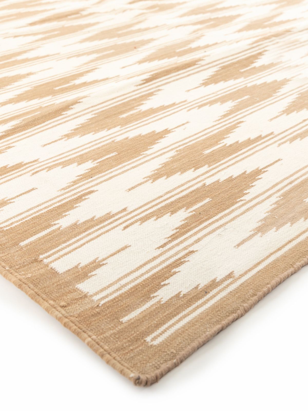 Beige Mist Ikat Dreams Rug close-up showing the cotton weave and geometric motif