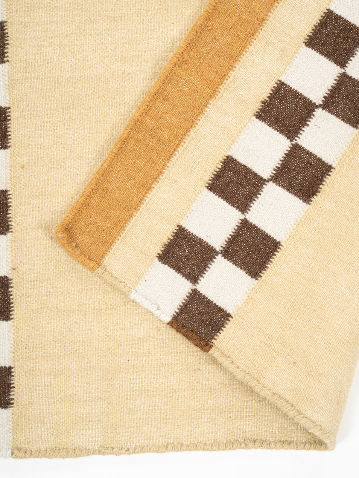 Checkerboard Stream Runner-Yellow detail showing edge binding and cotton finishing of the runner