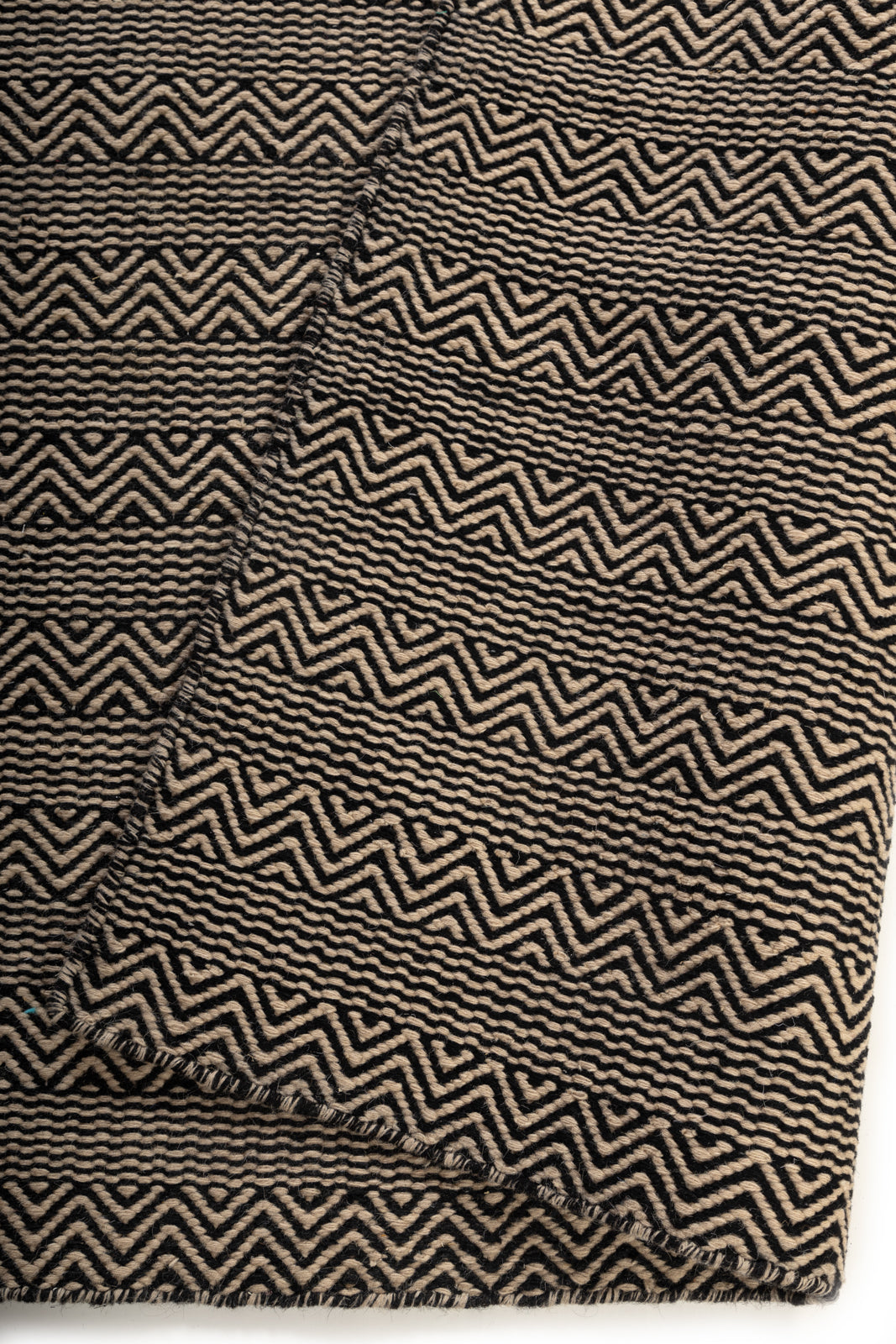Claybourne Shuttle Rug detail showing the textured wool surface and finishing