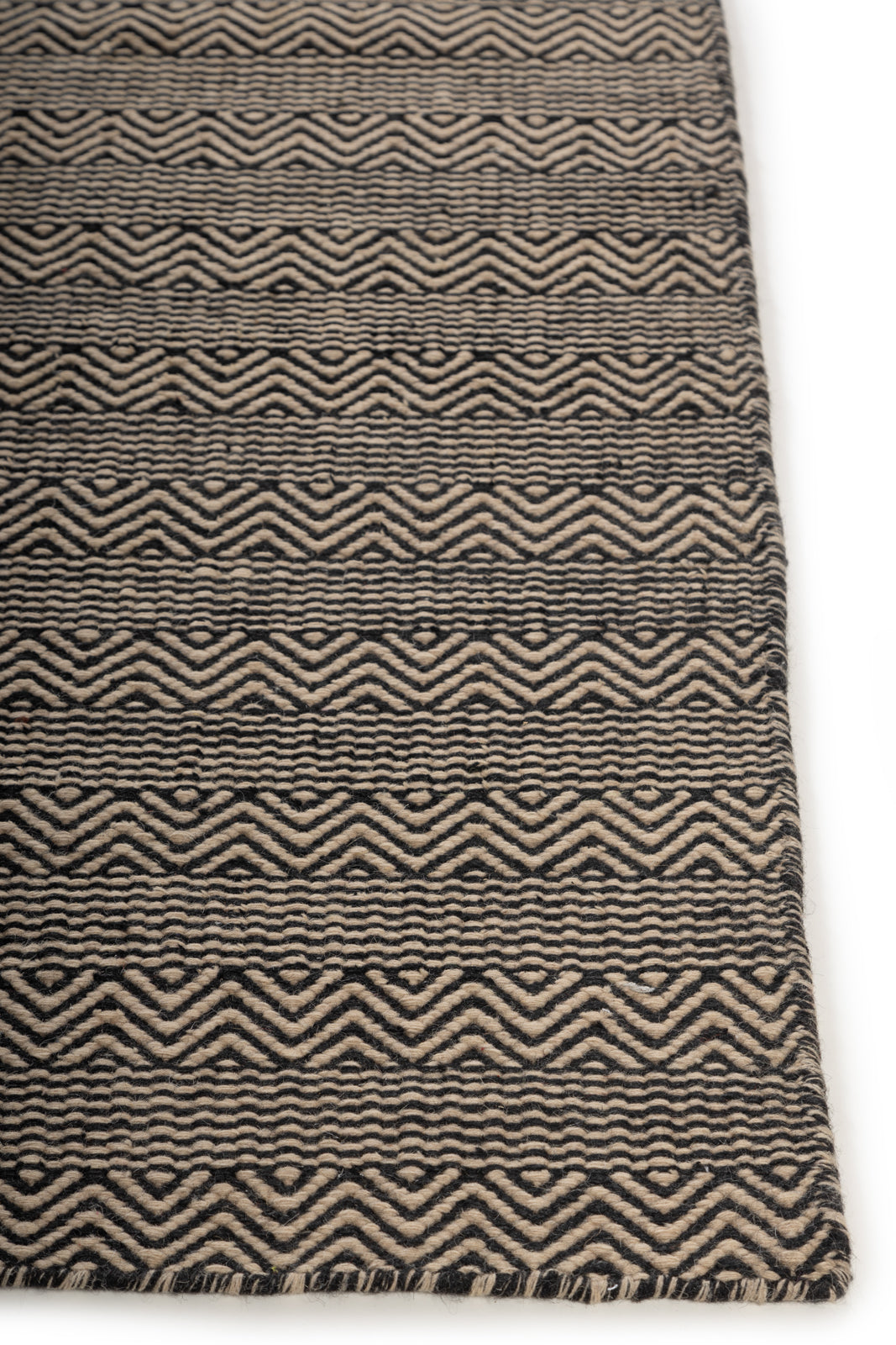 Claybourne Shuttle Rug wool rug styled in a living room interior