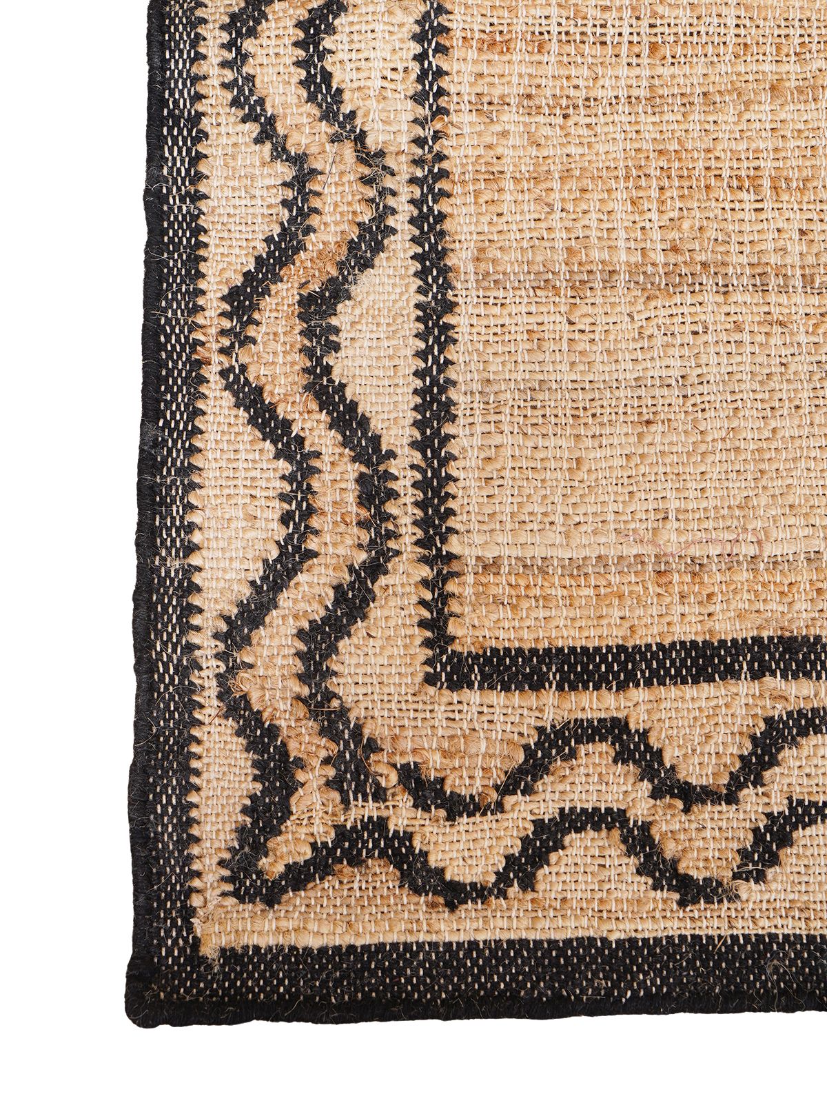 Dark Crest Double Wave Rug jute rug styled in a living room interior