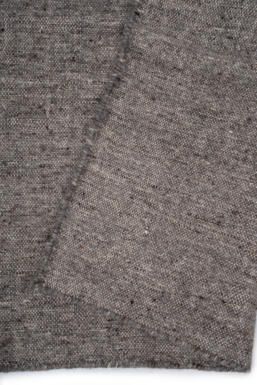 Earthen Essence Grey Wool Rug detail showing the textured wool surface and finishing