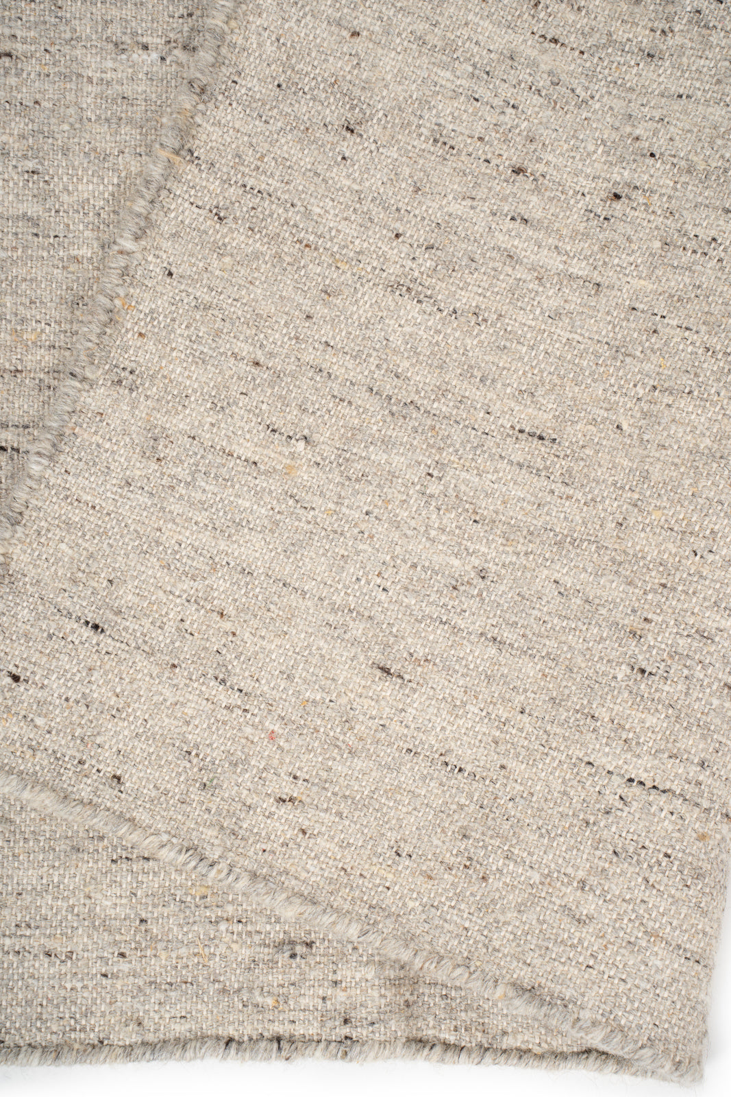 Earthen Essence Ivory Wool Rug detail showing the textured wool surface and finishing