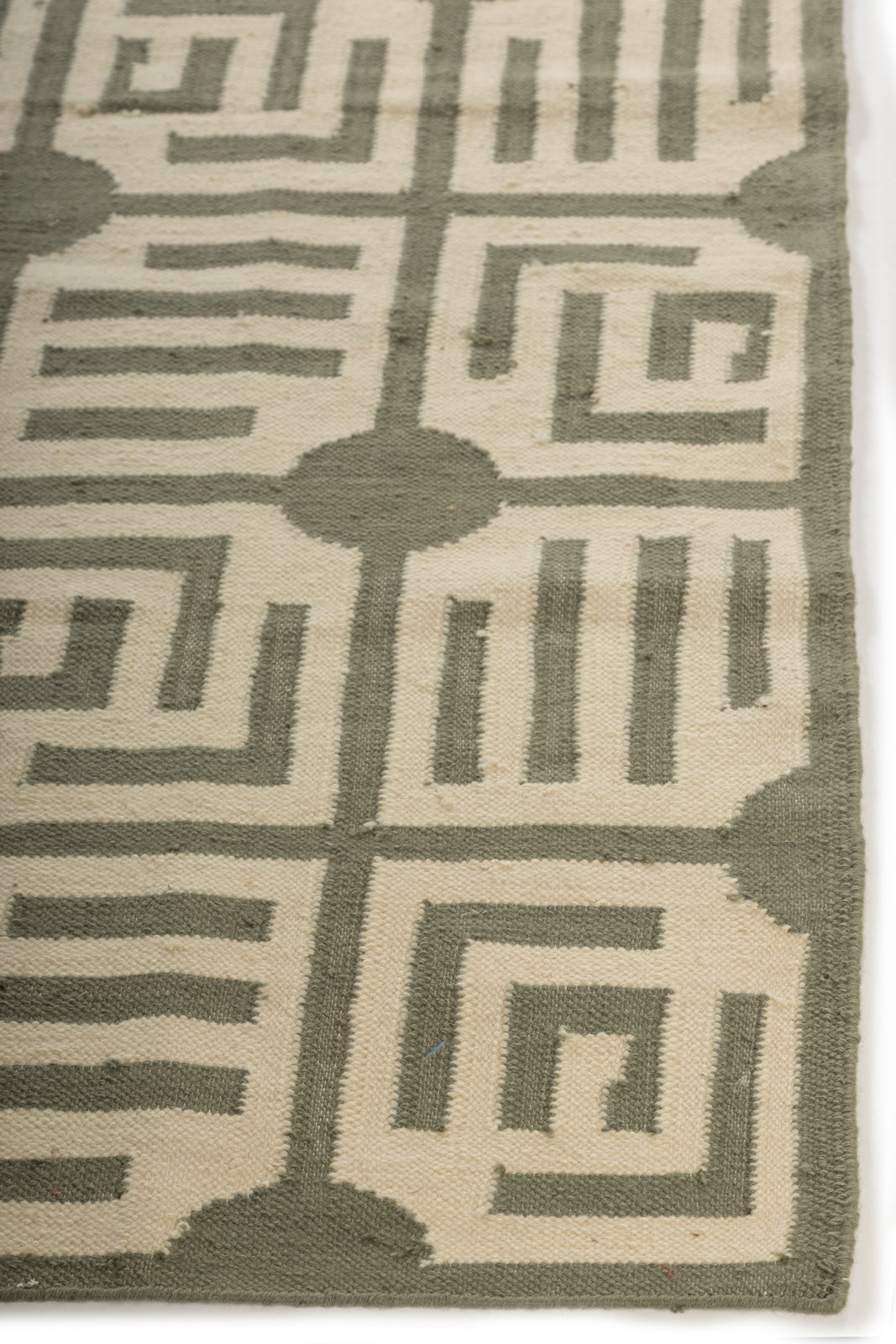 GeoEssence Wool Flatweave Rug wool rug styled in a living room interior