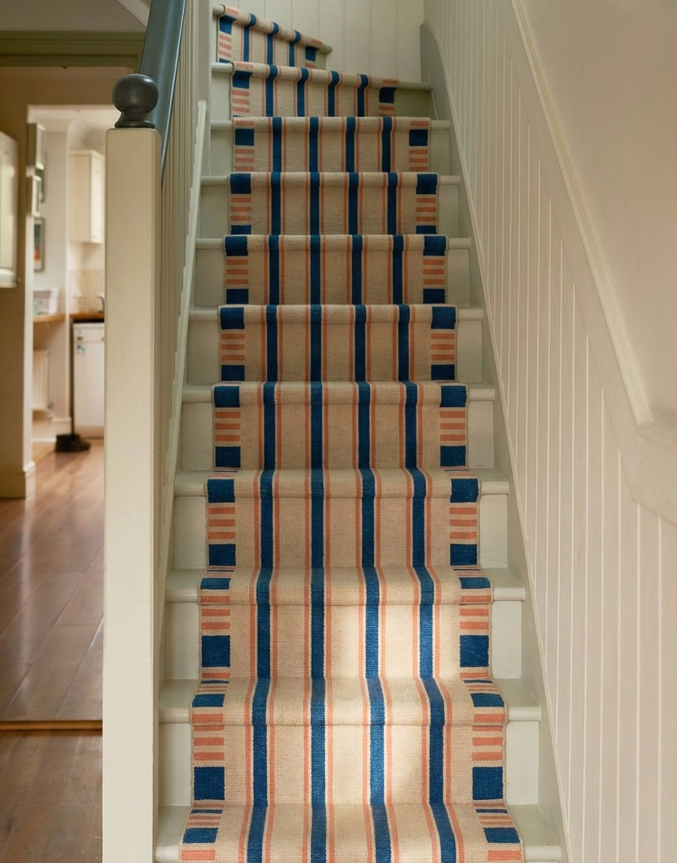 Indigo Stripes Wool Runner wool stair runner styled on a staircase in a designed interior