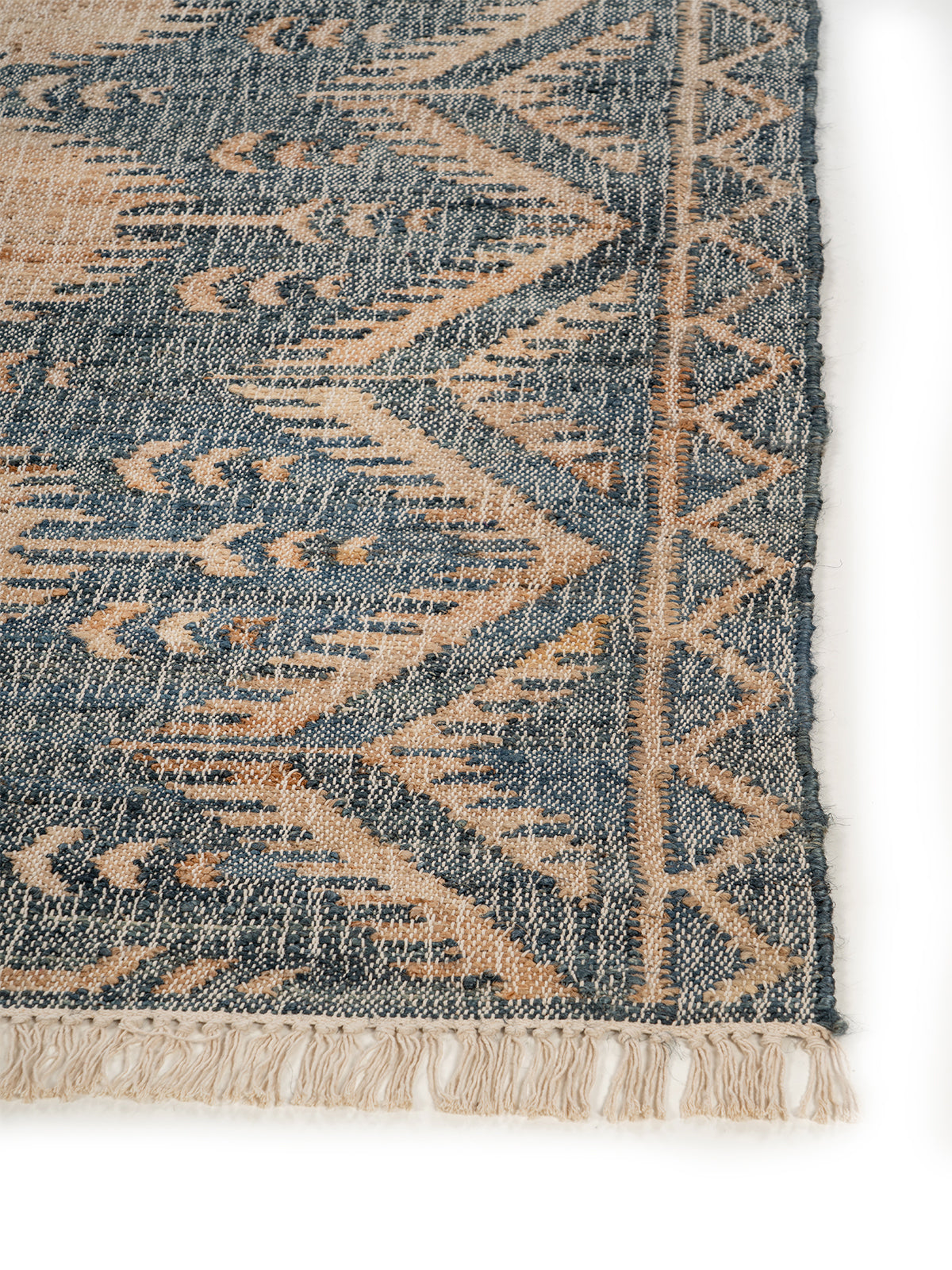 Indigo Tribal Diamond Jute Rug jute rug styled in a living room interior
