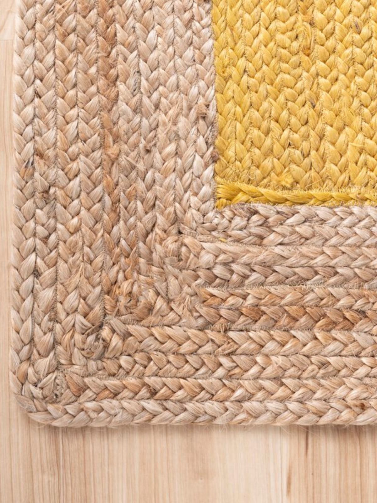 Juba jute bordered area runner-Yellow jute stair runner styled on a staircase in a designed interior