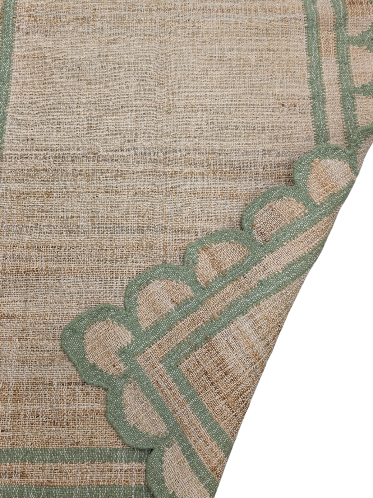Kigali scalloped hemp rug- Green detail showing the textured hemp surface and finishing