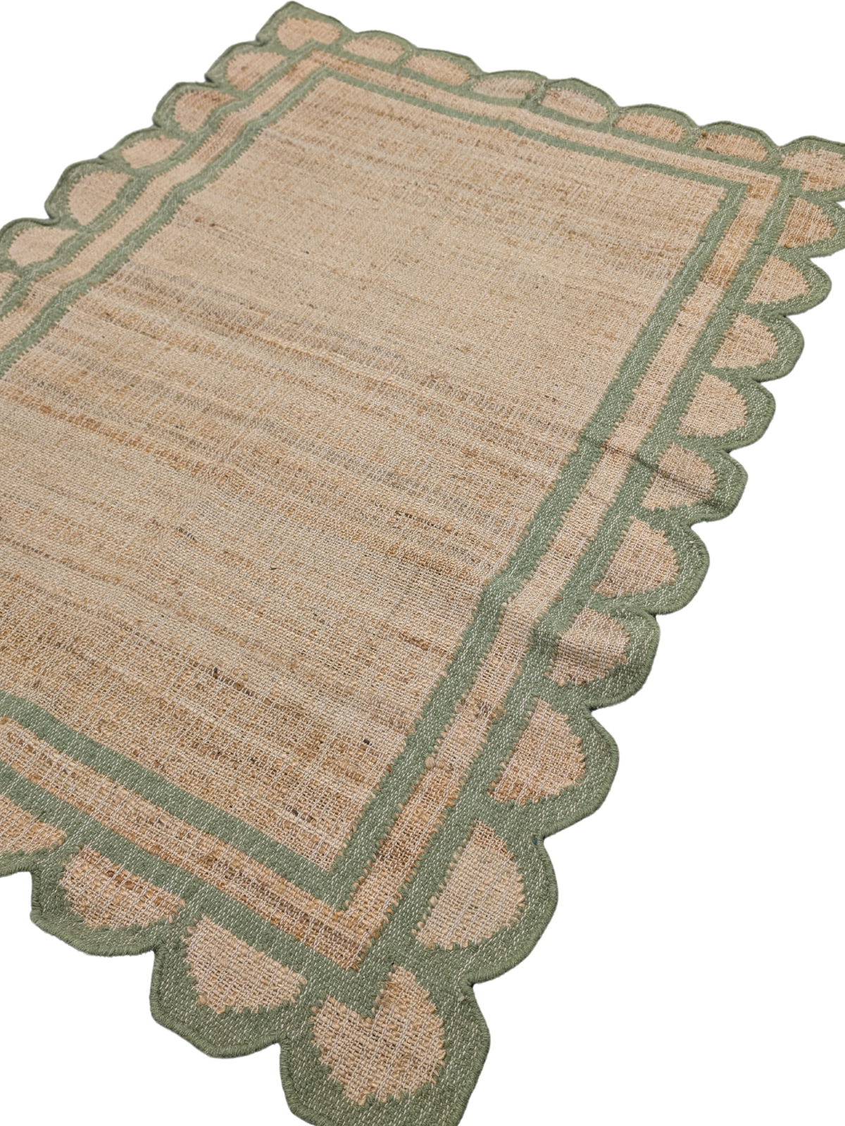 Kigali scalloped hemp rug- Green hemp rug styled in a living room interior
