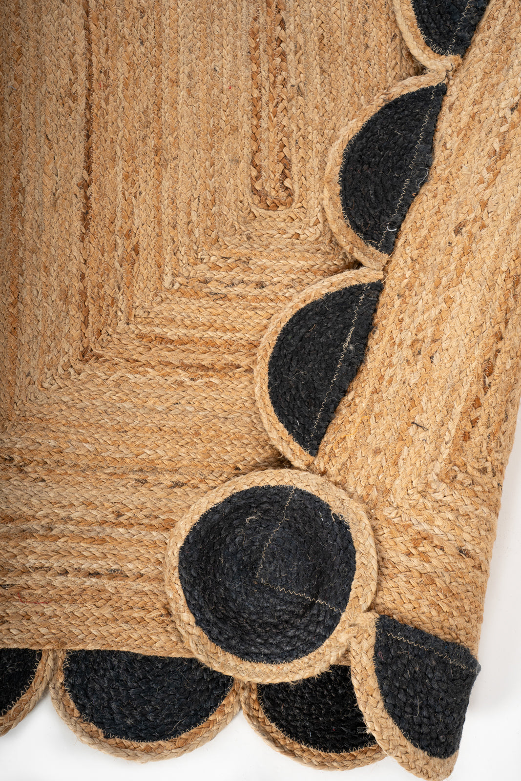 Kribi scalloped jute area rug-Jet Black detail showing the textured jute surface and finishing