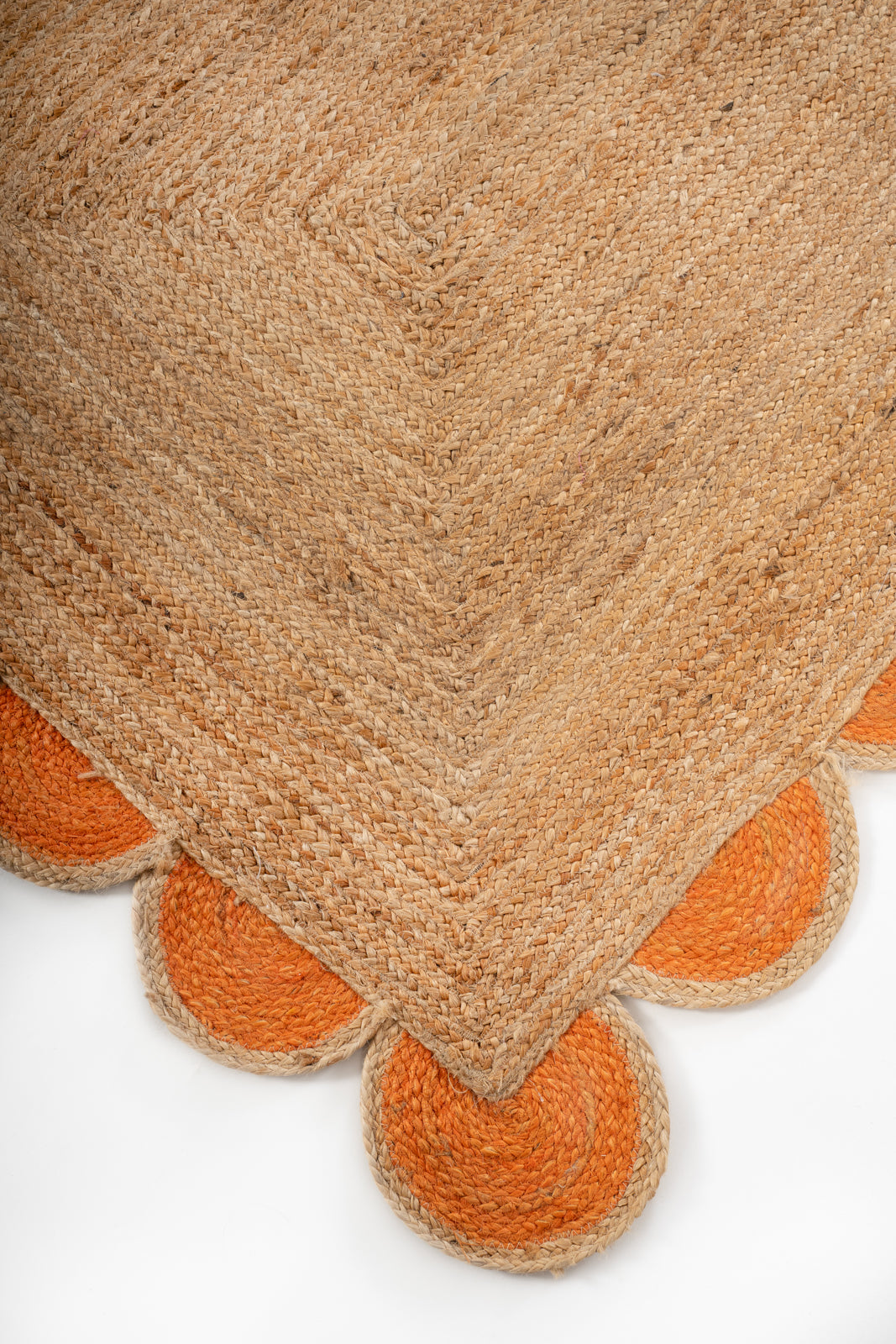 Kribi scalloped jute area rug-Orange close-up showing the jute weave and surface texture