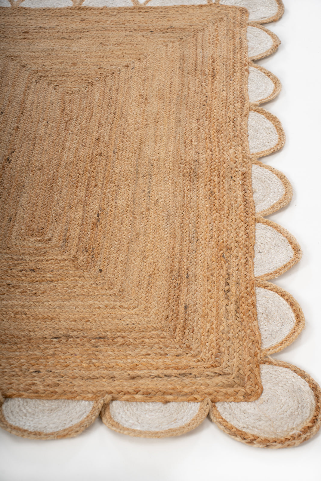 Kribi scalloped jute area rug-White jute rug styled in a living room interior
