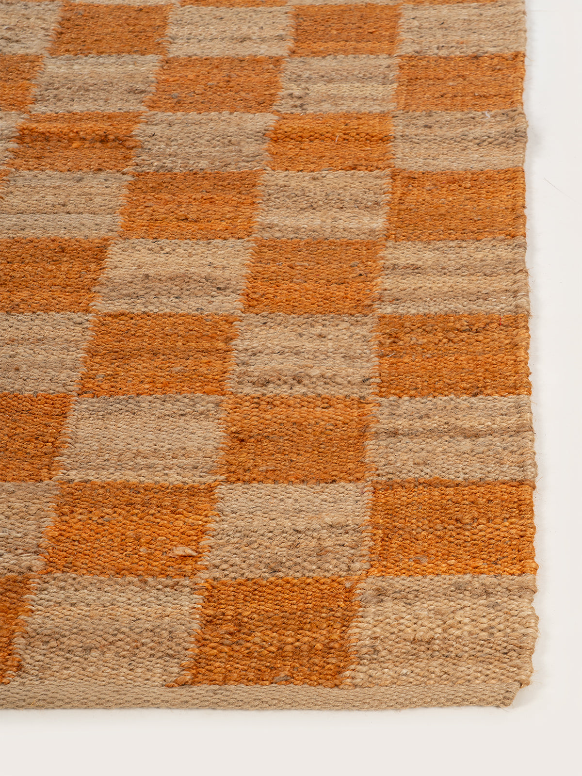 Lincoln checkered jute rug-Orange jute rug styled in a living room interior