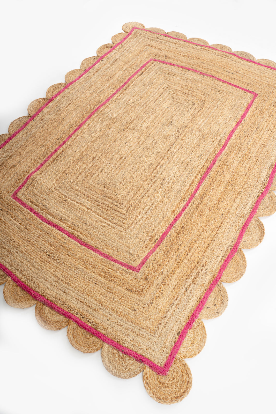 Loko scalloped area rug-Pink cotton rug styled in a living room interior