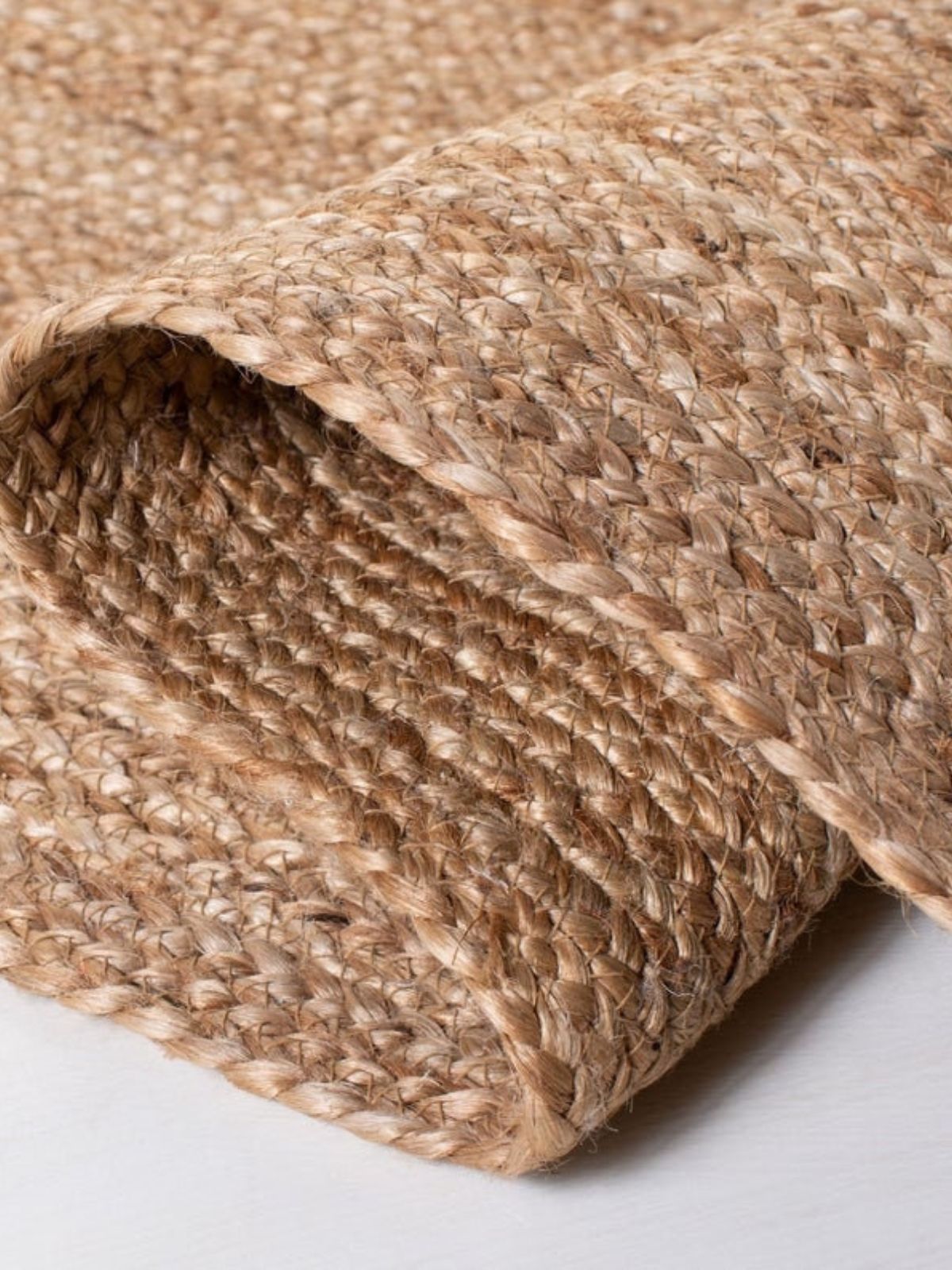 Lusaka natural jute braided area rug detail showing the textured jute surface and finishing