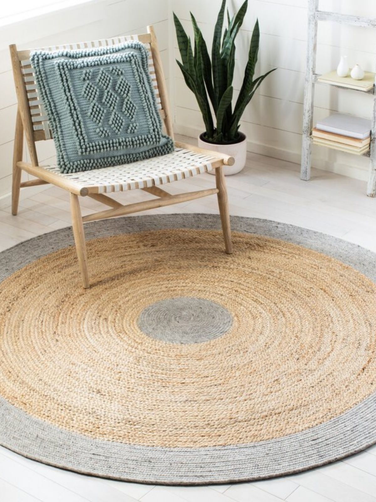 Maseru jute bordered round area rug jute rug styled in a living room interior