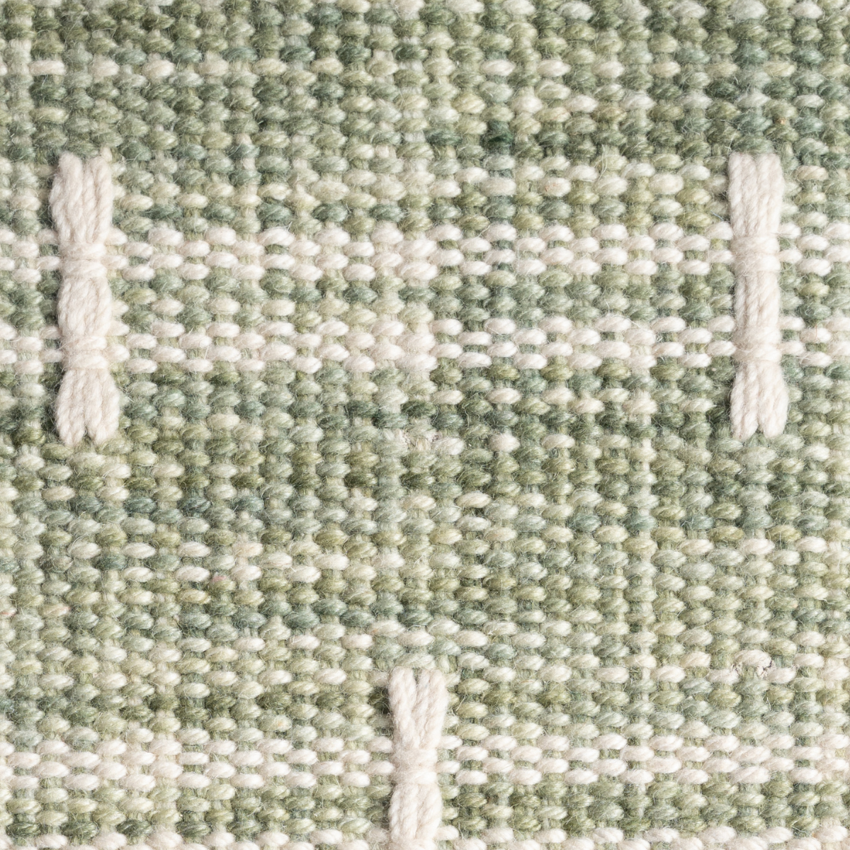 Meridian Loom : Meadow Cross close-up showing the wool weave and geometric motif