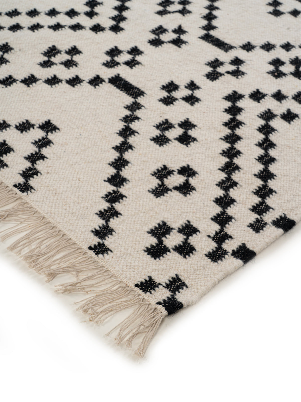 Monochrome Berber Flatweave Rug close-up showing the wool weave and geometric motif