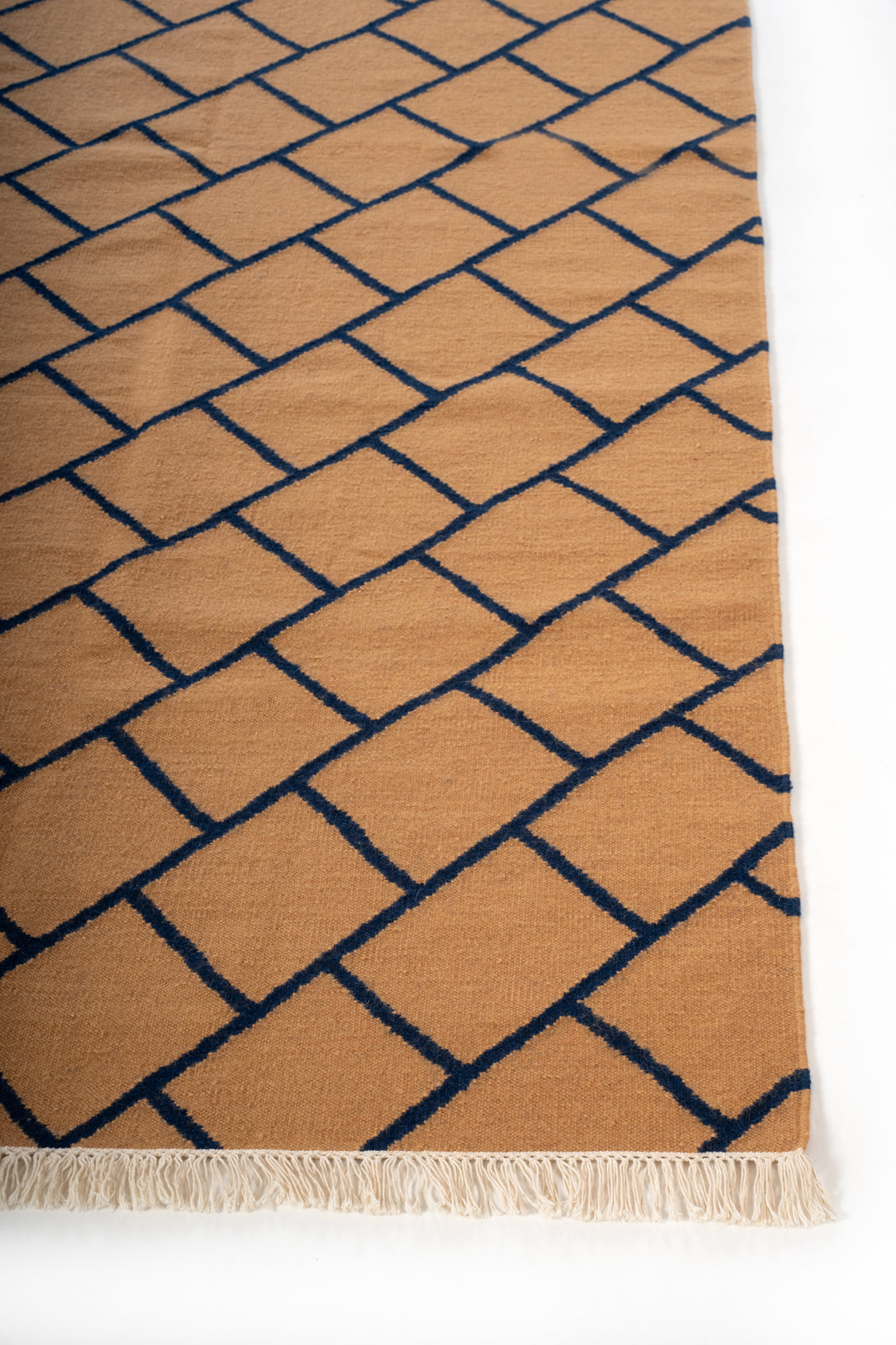 Ochre Lattice Wool Rug wool rug styled in a living room interior