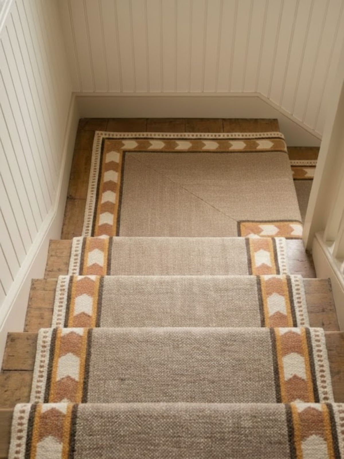 Rust Moor Runner cotton stair runner styled on a staircase in a designed interior