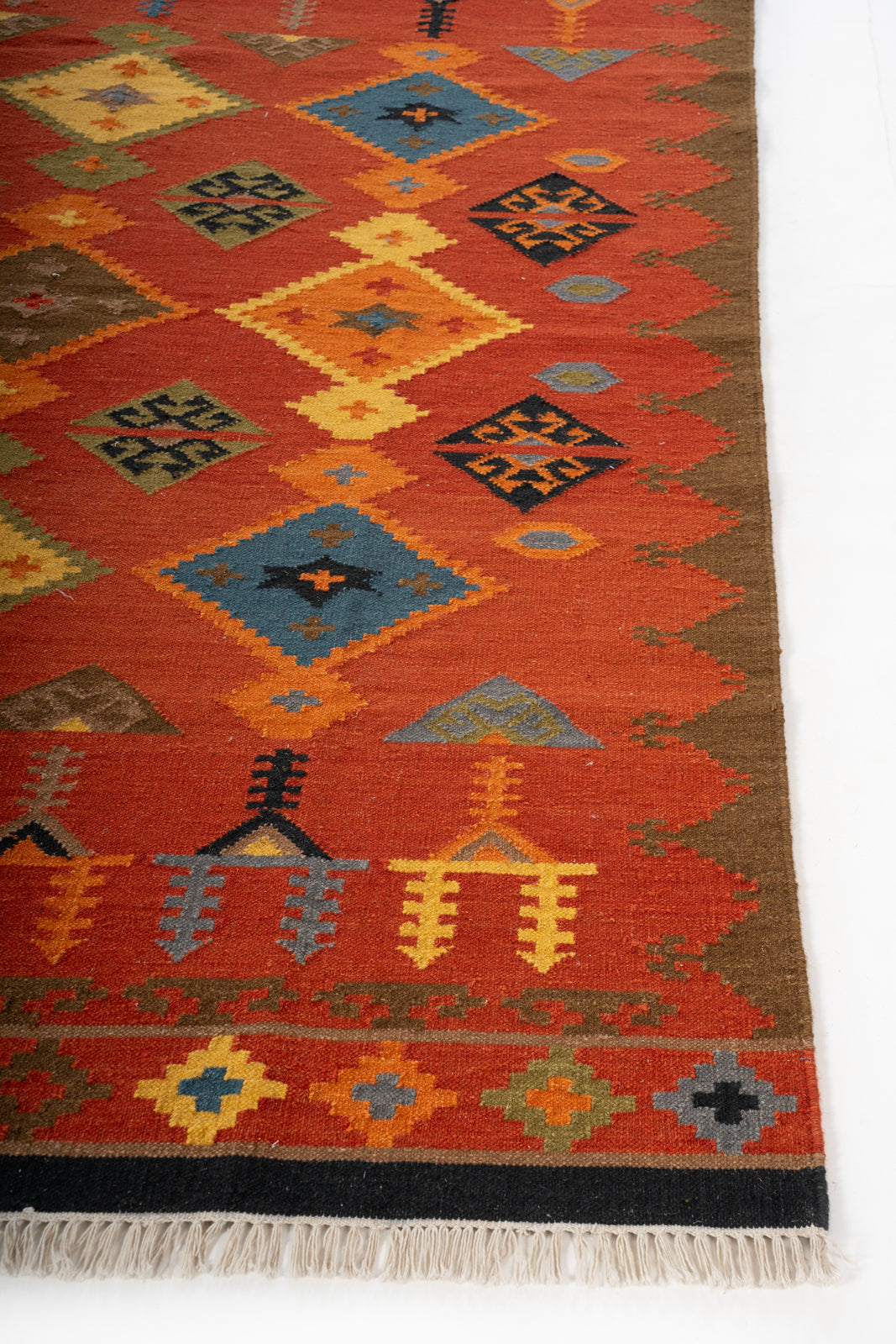 Saffron Horizon Wool Kilim Rug wool rug styled in a living room interior