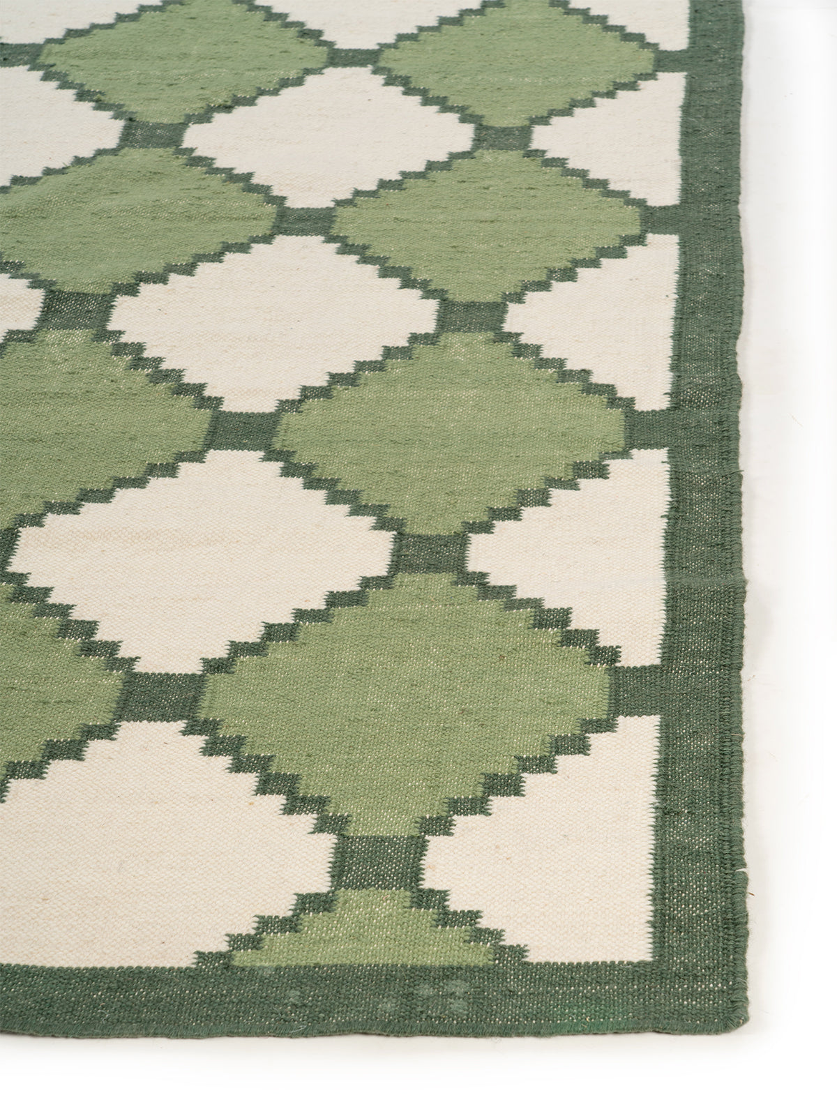 Sage Harlequin Wool Flatweave Rug wool rug styled in a living room interior