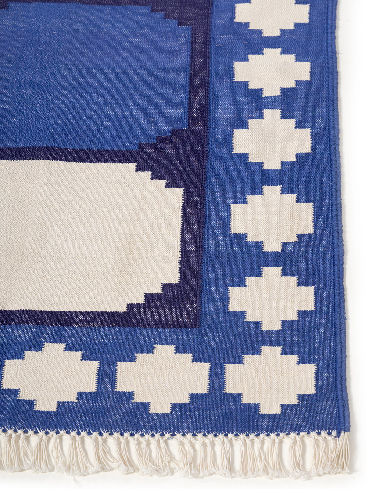 Sapphire Essence Flatweave Rug-Navy cotton rug styled in a living room interior