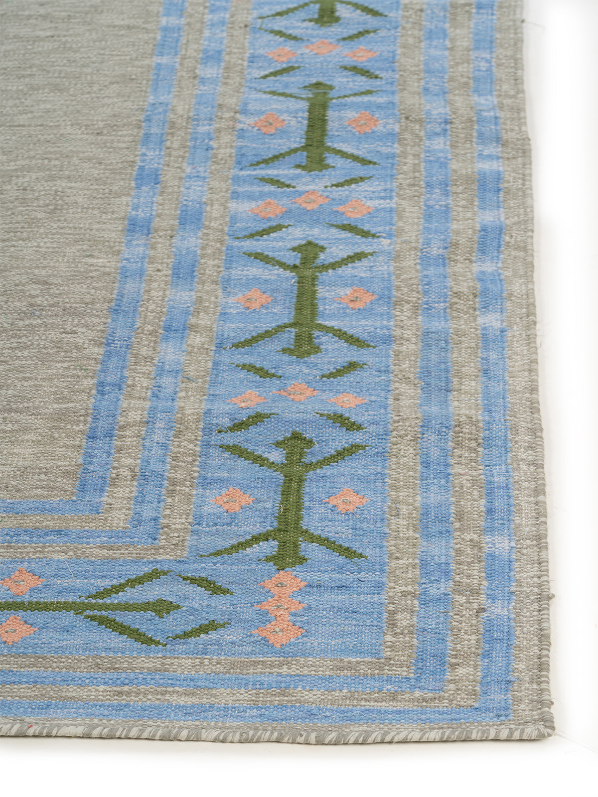 Scandi Folk Border Wool Rug wool rug styled in a living room interior