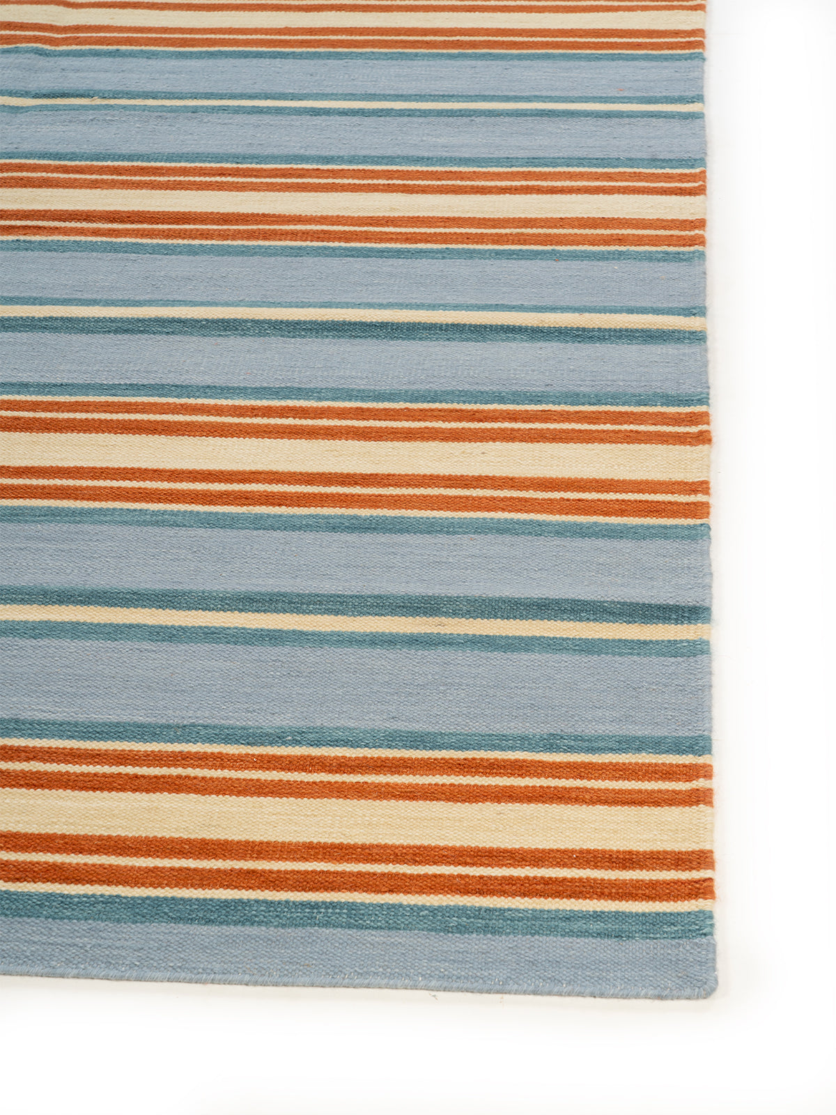 Seaside Stripe Wool Rug wool rug styled in a living room interior