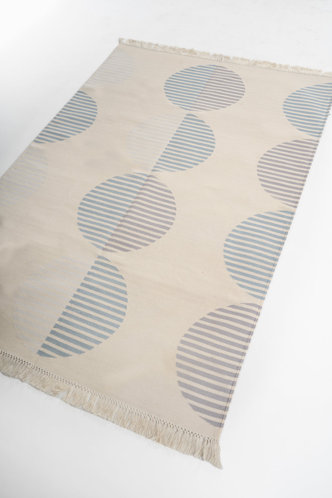 Striped Circles Reversible Handwoven Cotton Rug cotton rug styled in a living room interior