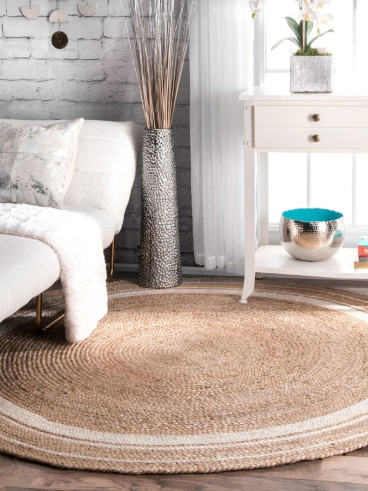 Suez bordered jute braided round rug jute rug styled in a designed interior