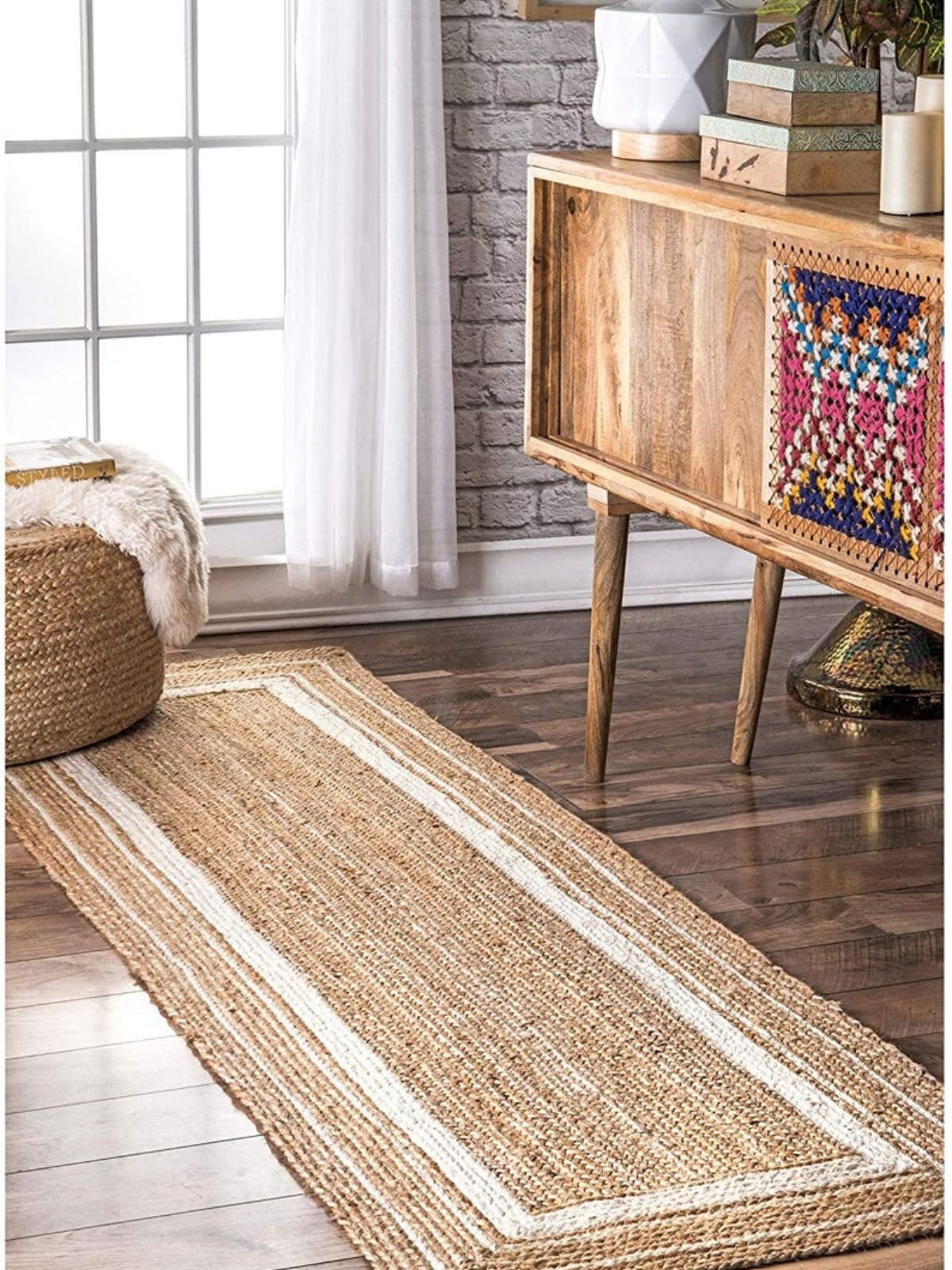 Suez Bordered Jute Braided Runner jute stair runner styled on a staircase in a designed interior