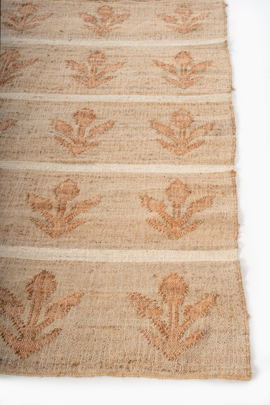 Sunset Grove Handwoven Jute Rug jute rug styled in a living room interior