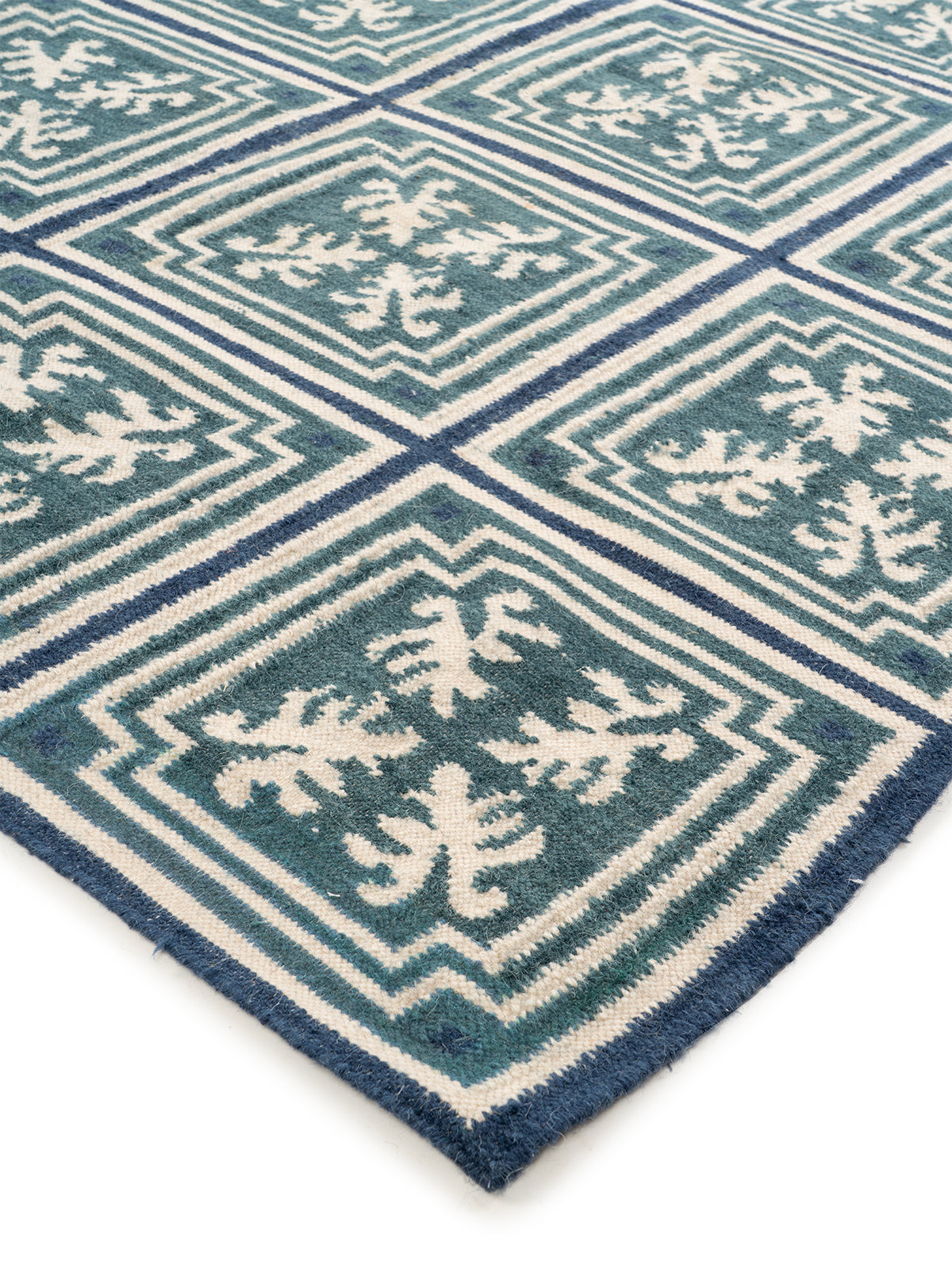 Teal & Indigo Grid Rug close-up showing the wool weave and geometric motif