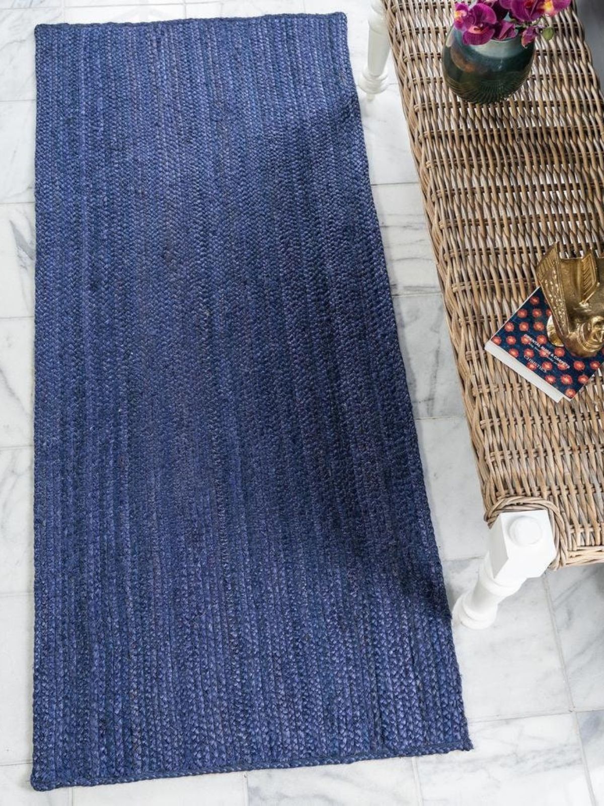Thaba braided area rug-Navy jute rug styled in a living room interior