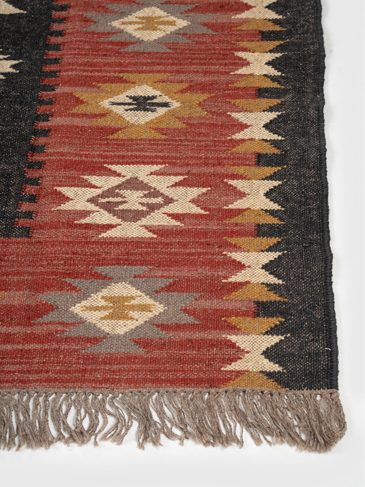 The Ancestral Glyph Rug wool rug styled in a living room interior