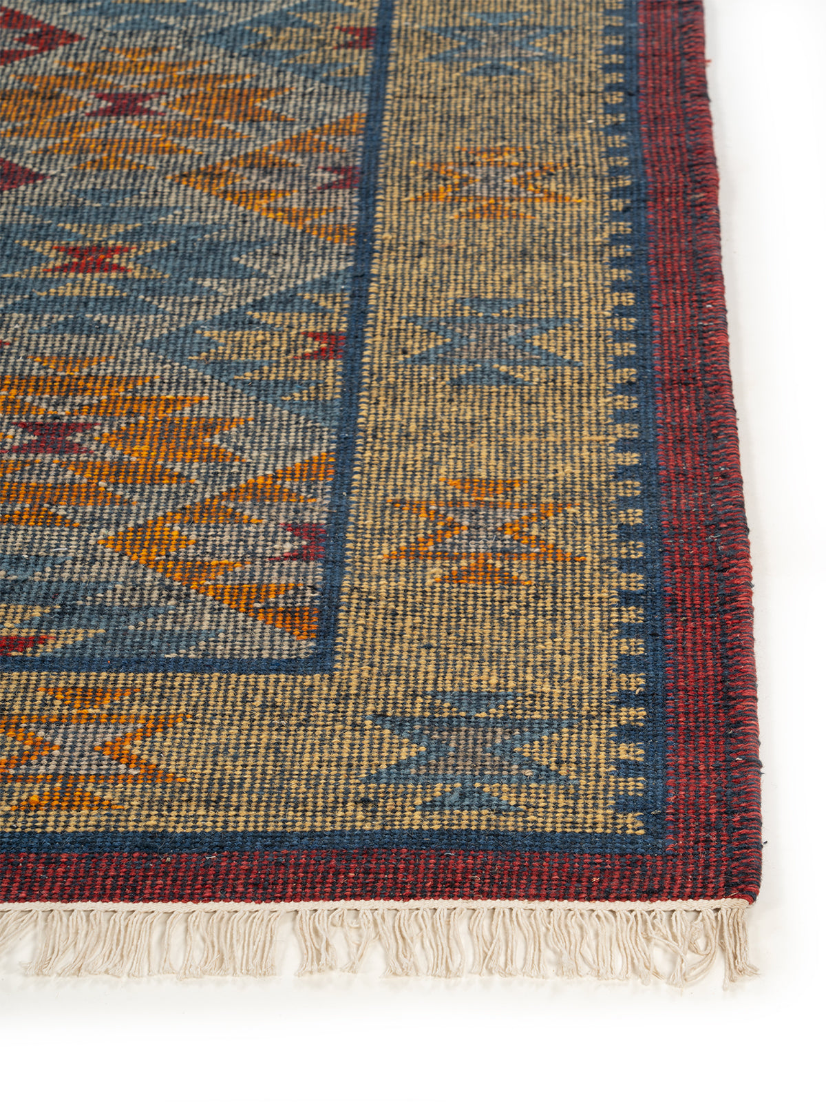 The Aztec Medallion Rug wool rug styled in a living room interior
