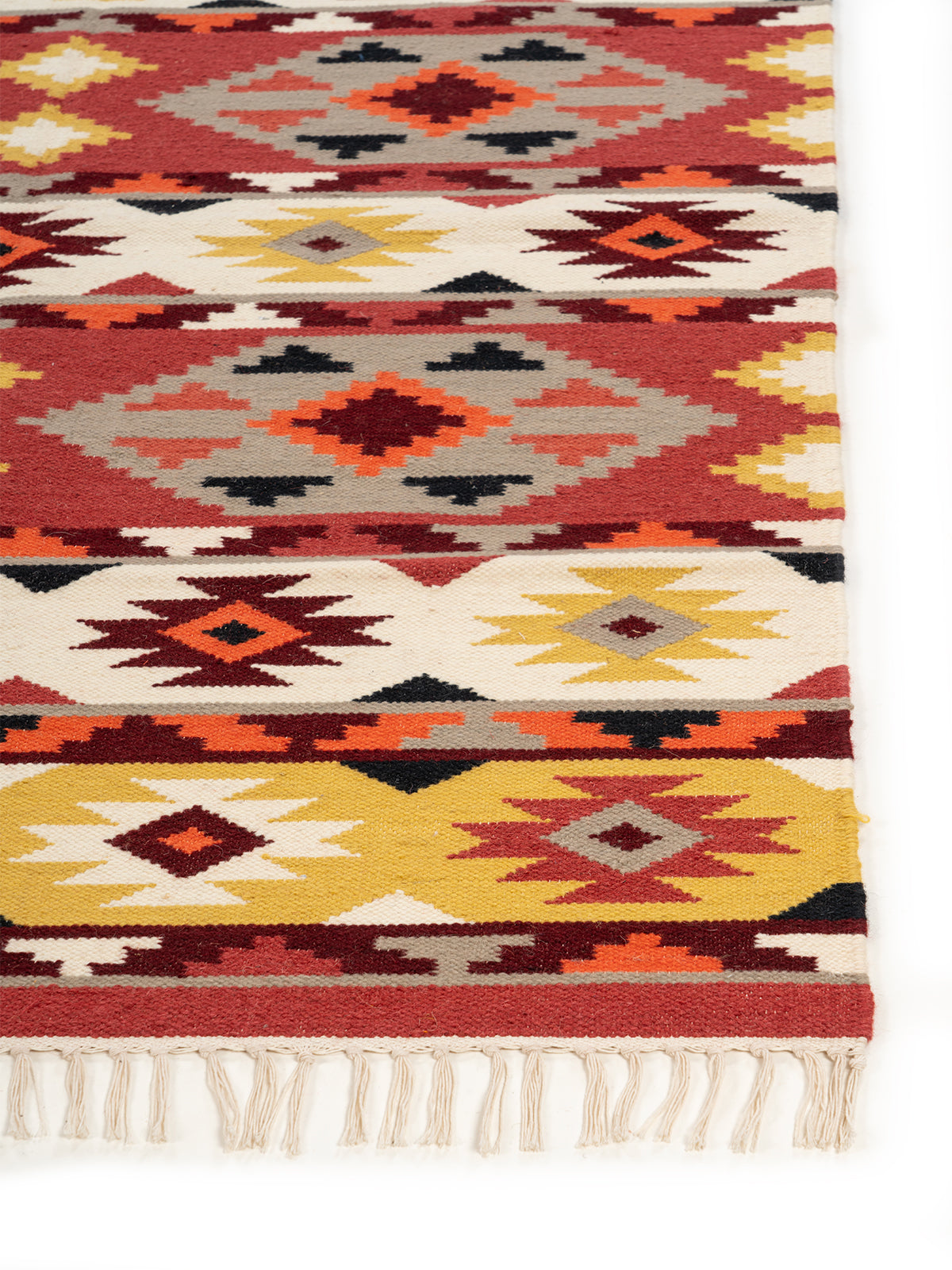 The Canyon Sunset Rug wool rug styled in a living room interior